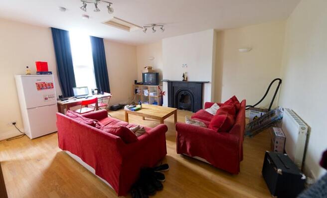 Bright and spacious living room featuring comfo...