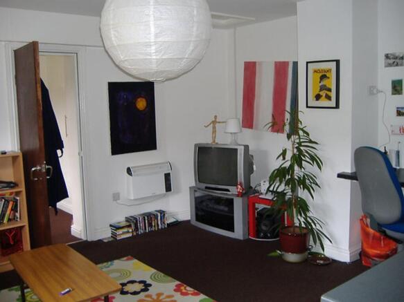 This vibrant living room features a cozy atmosp...