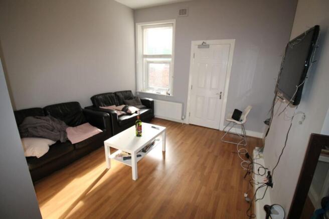 Spacious and inviting living room featuring com...