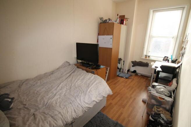 Cozy double bedroom featuring ample natural lig...