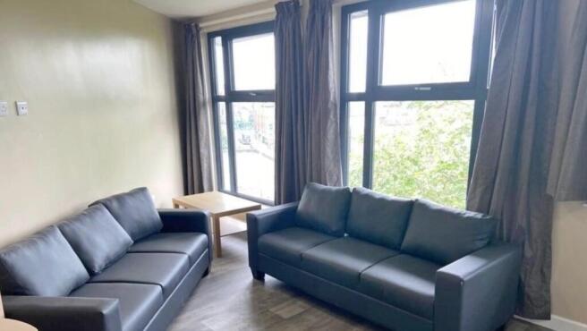 Bright and inviting living room featuring large...