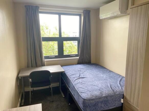 Cozy double bedroom featuring a comfortable bed...