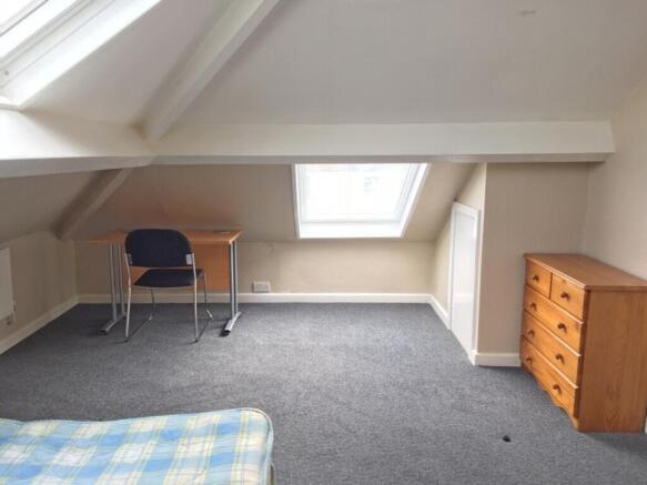 This spacious double bedroom features ample nat...