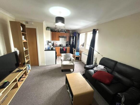 A cozy living room featuring a comfortable seat...