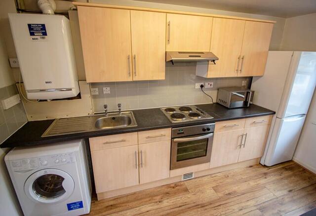 Bright and modern kitchen featuring ample stora...