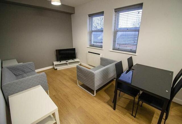 Spacious and inviting living room featuring mod...