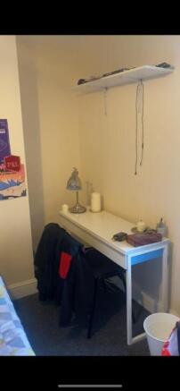 This cozy double bedroom features a comfortable...