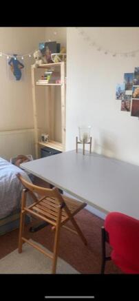 This cozy double bedroom features a comfortable...