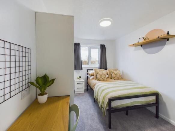 A bright and inviting double bedroom with moder...