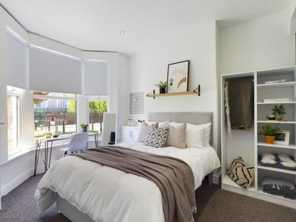 A bright and inviting double bedroom with moder...