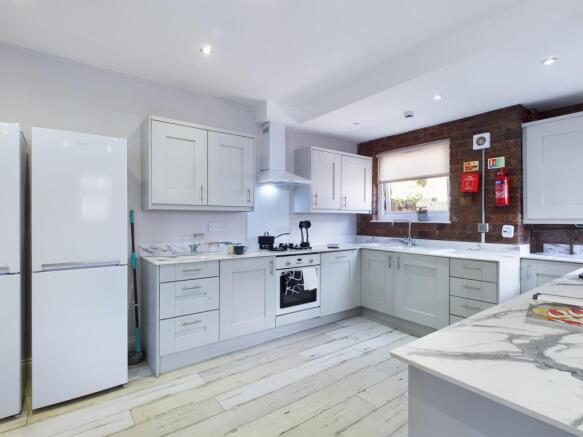 A spacious and modern kitchen with sleek cabine...