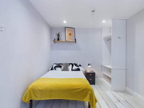 A bright and inviting double bedroom with moder...