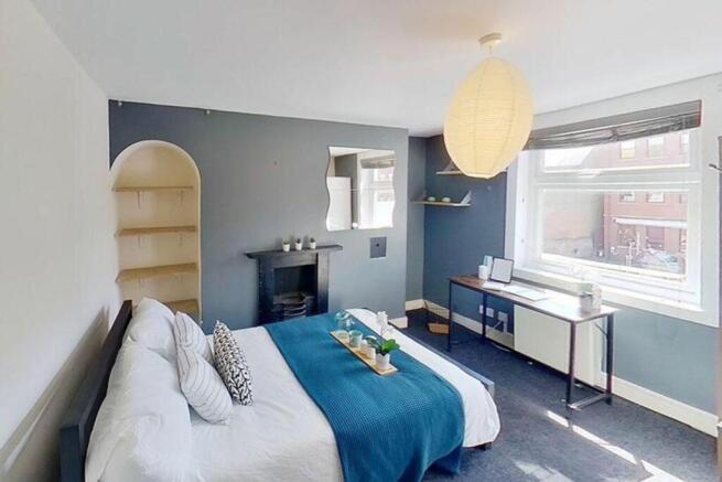 This stylish double bedroom features ample natu...