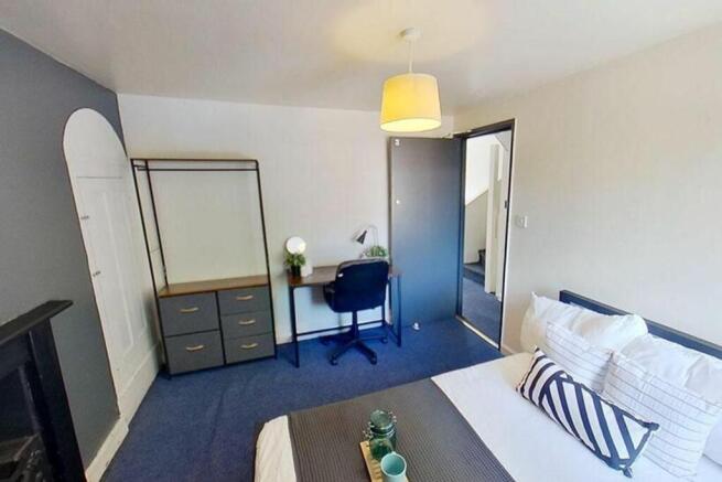 This inviting double bedroom features a cozy la...