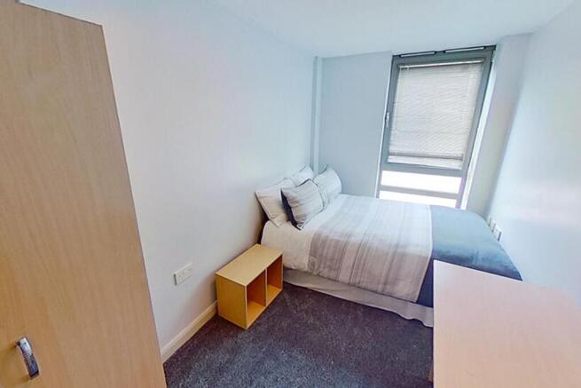 This inviting double bedroom features ample nat...