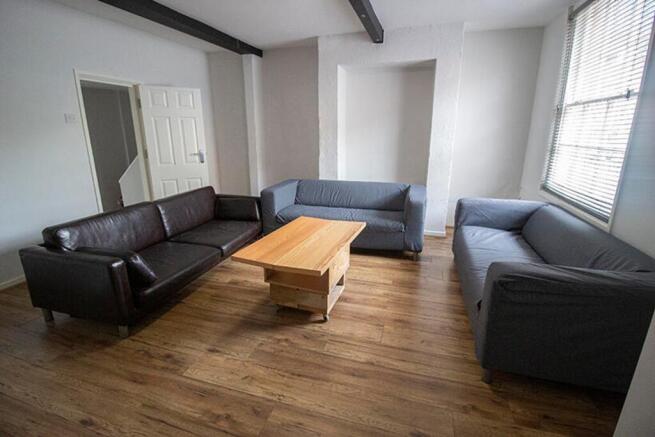 Spacious living room featuring comfortable seat...