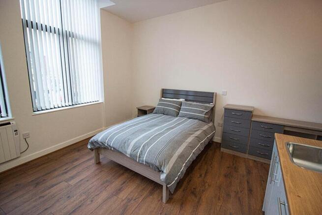 This inviting double bedroom features large win...