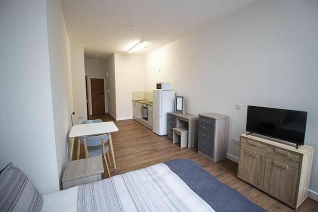 A cozy double bedroom featuring a comfortable b...