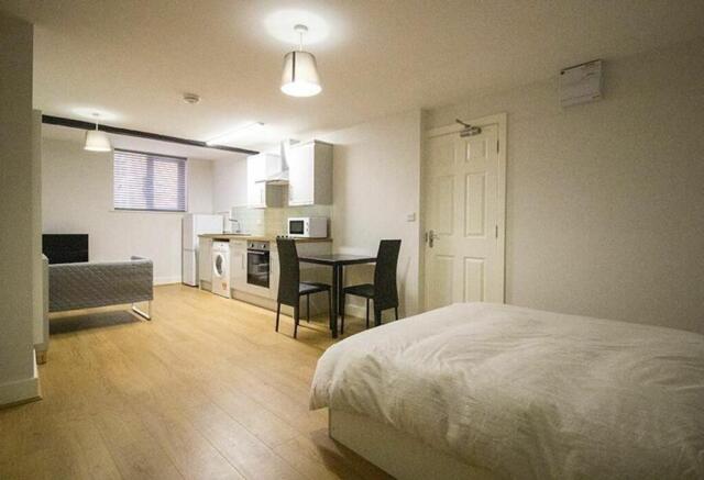 A bright and modern double bedroom featuring a ...
