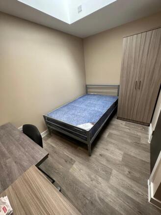 A bright and inviting double bedroom featuring ...