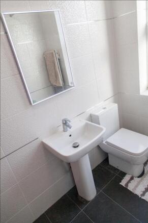 Bright and modern bathroom featuring sleek fixt...