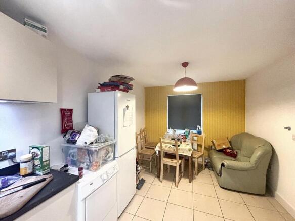 A cozy kitchen area featuring a dining table, a...