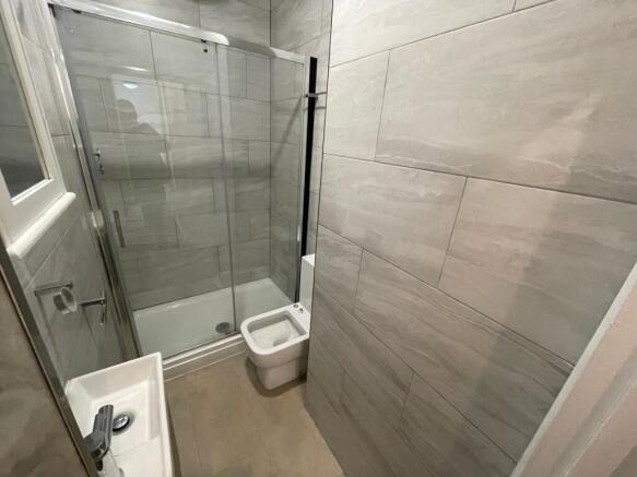 A modern bathroom suite featuring a sleek showe...