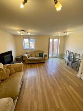 Spacious living room featuring abundant natural...