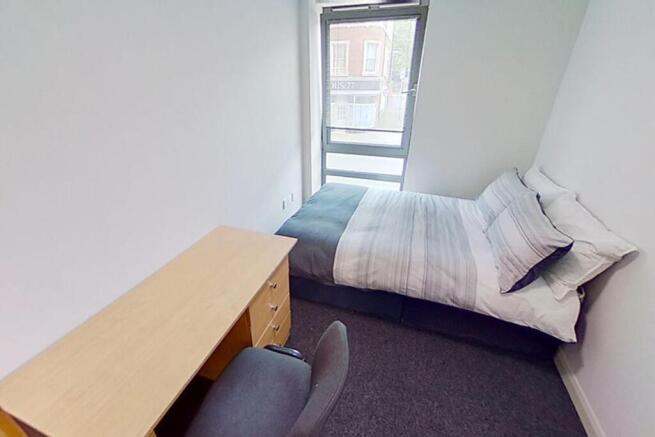 This inviting double bedroom features a cozy la...