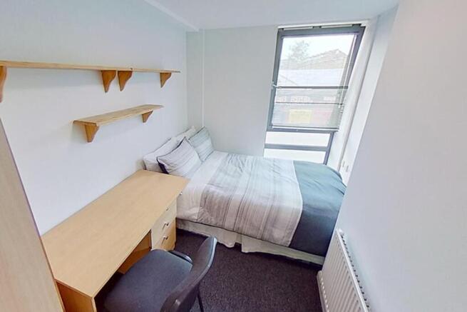 Spacious double bedroom featuring a comfortable...