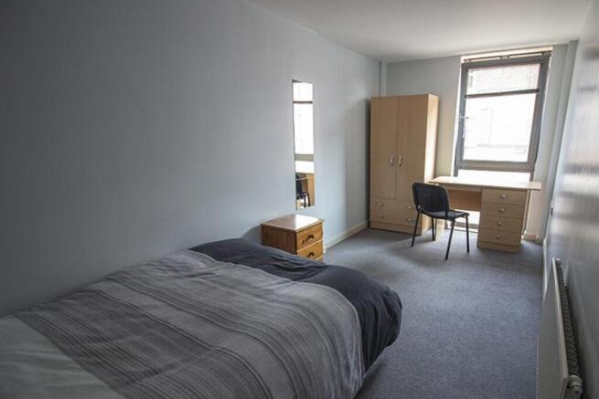 Spacious double bedroom featuring ample natural...