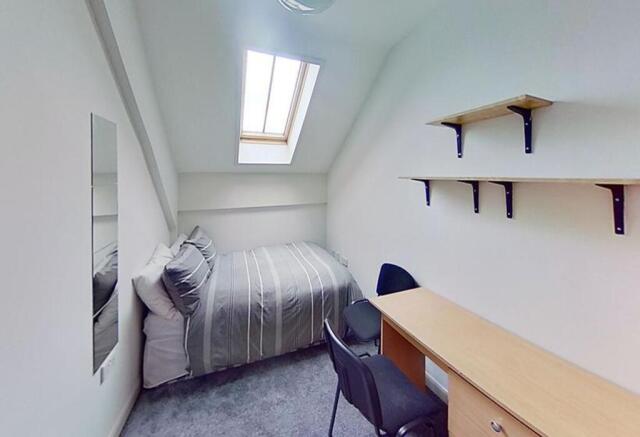A cozy double bedroom featuring a comfortable b...