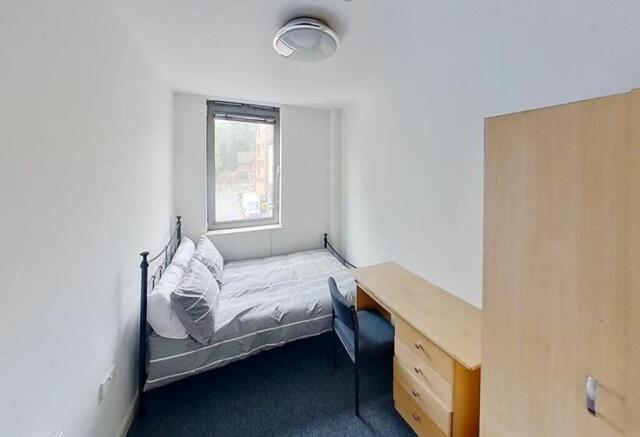Cozy double bedroom featuring a comfortable bed...