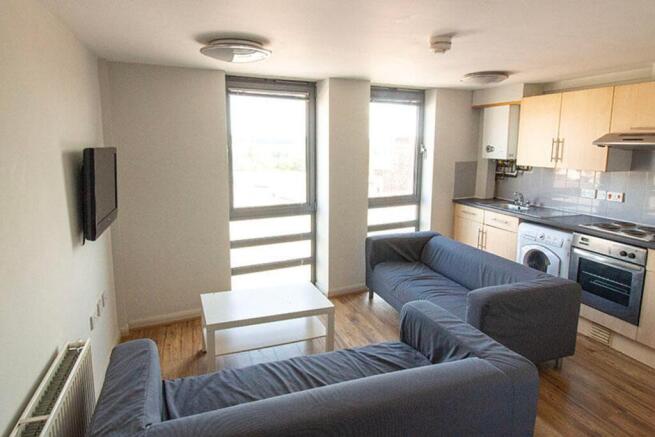 A bright and spacious living room featuring lar...