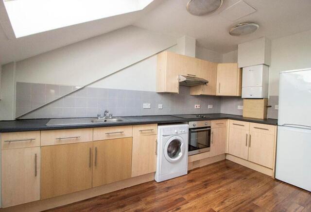 Modern kitchen featuring sleek cabinetry, ample...