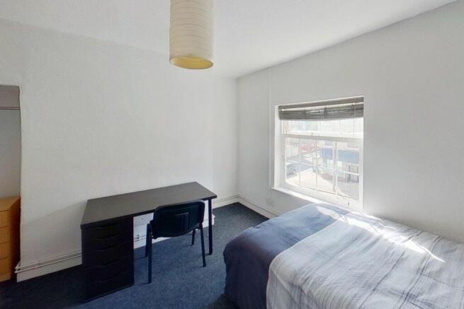 Bright and spacious double bedroom featuring a ...