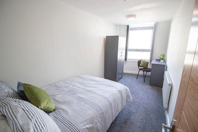 A bright and inviting double bedroom featuring ...