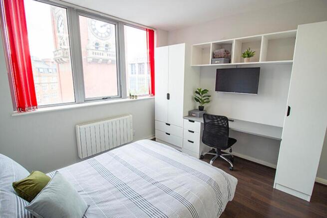 Bright and inviting double bedroom featuring la...