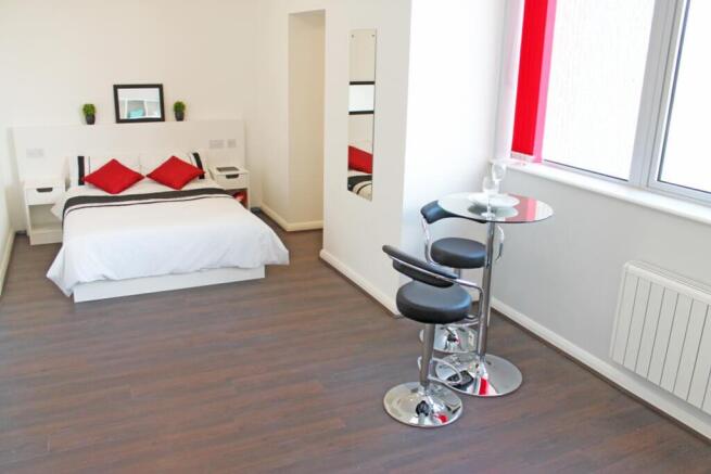 Bright and welcoming double bedroom featuring a...
