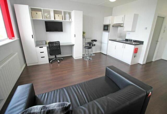 This stylish double bedroom features a cozy sea...
