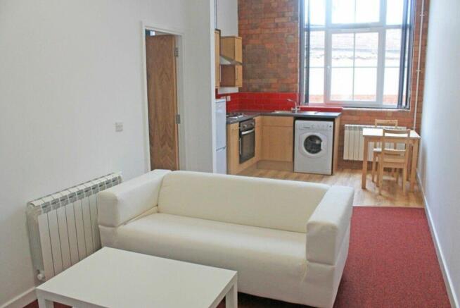 A bright and inviting living room featuring lar...
