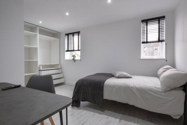 A modern and spacious double bedroom with excel...