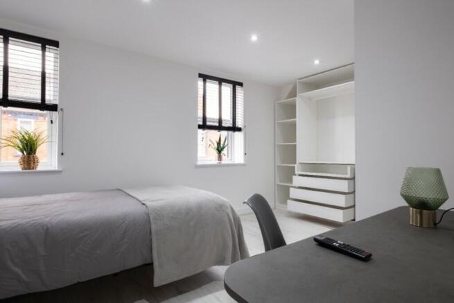 A bright and inviting double bedroom featuring ...