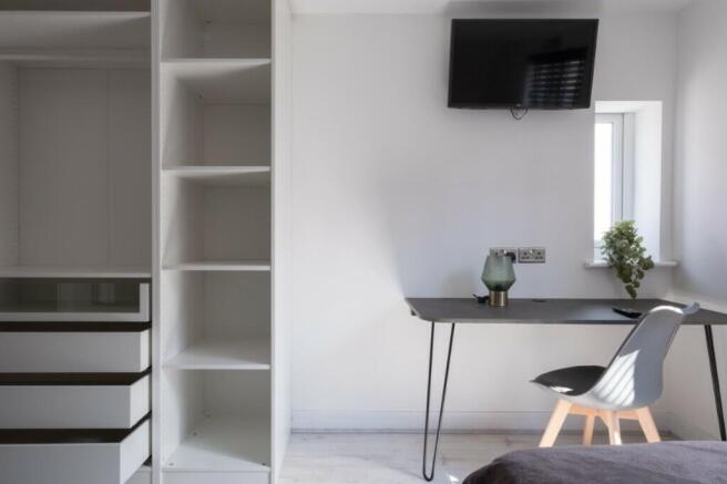 A stylish and modern double bedroom featuring a...