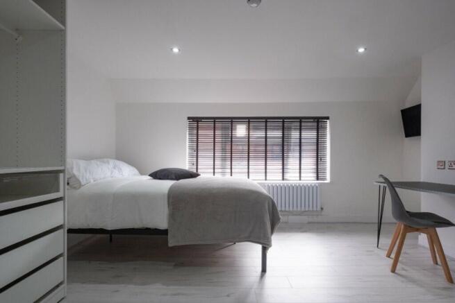 Bright and spacious double bedroom featuring a ...