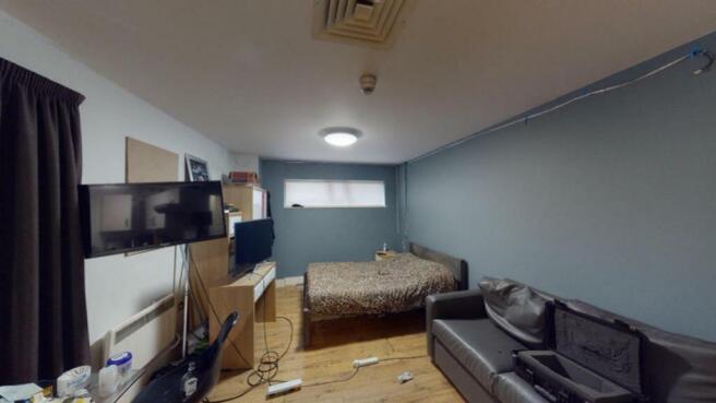 Cozy double bedroom featuring a comfortable bed...