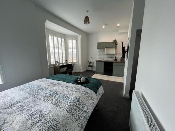 This inviting double bedroom features a cozy am...