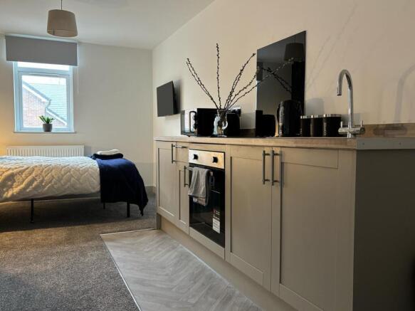 This stylish double bedroom features a cozy lay...