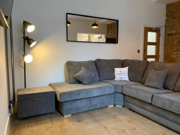 This stylish living room features a contemporar...