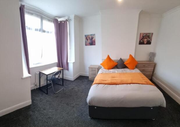 A bright and inviting double bedroom featuring ...